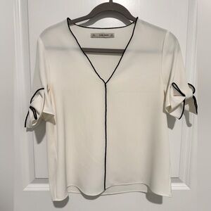 Zara White V-Cut Top with Black Trim and Bow Detailing on the Sleeves
